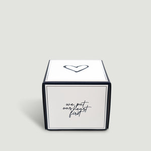 White box with black text and heart symbol on a light gray background