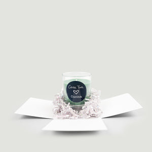 Candle in a decorative box with a heart-shaped label on a light gray background