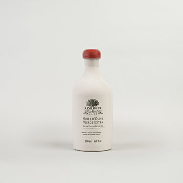 A bottle of A L'OLIVIER E.V. OIL CROCK FRANCE, a white bottle with a red cap and label.