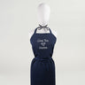 A navy blue kitchen apron with white text 'Casa Tua' and a heart symbol followed by 'Cucina' displayed on a mannequin.