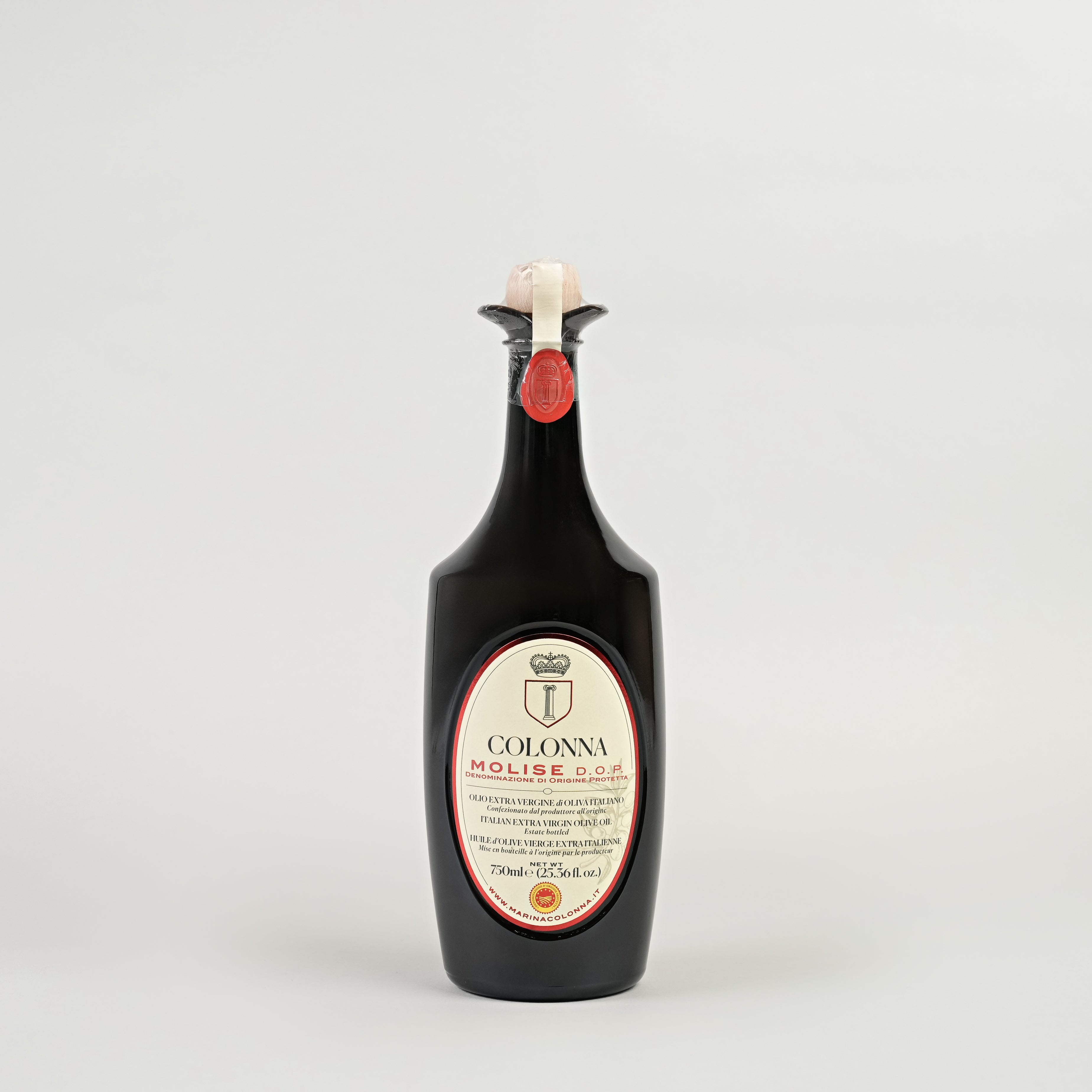 A bottle of Colonna DOP MOLISE Extra Virgin Olive Oil with a label indicating it is 750 ml. The bottle is upright and has a dark tint with a red cap.