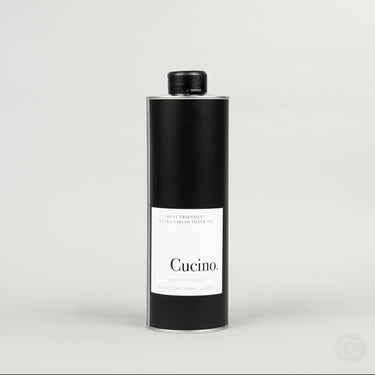 A black bottle of extra virgin olive oil with a white label that reads 'Cucino.'