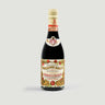Bottle of Giuseppe Giusti Modena with decorative label on a white background