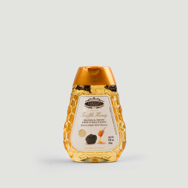 Honey bottle with a gold cap on a light gray background 250g.