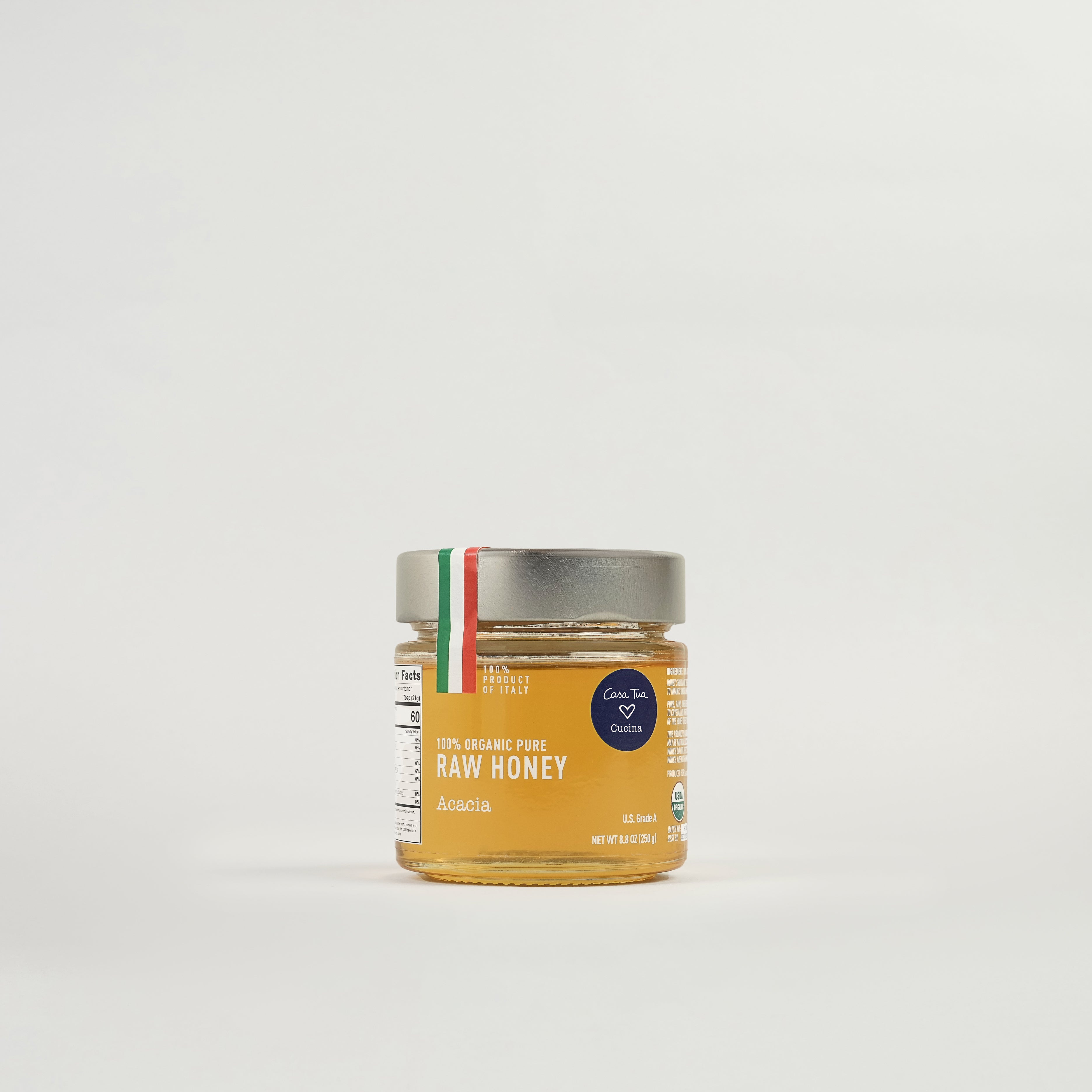 A jar of honey with a label indicating it is '100% Pure Honey' and has a net content of 2 x 1.